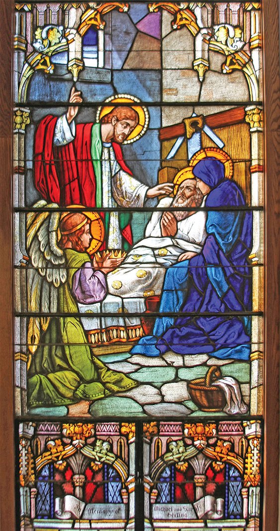 Stained glass depicting the peaceful death of St. Joseph, in St. Thomas the Apostle Church in St. Thomas.